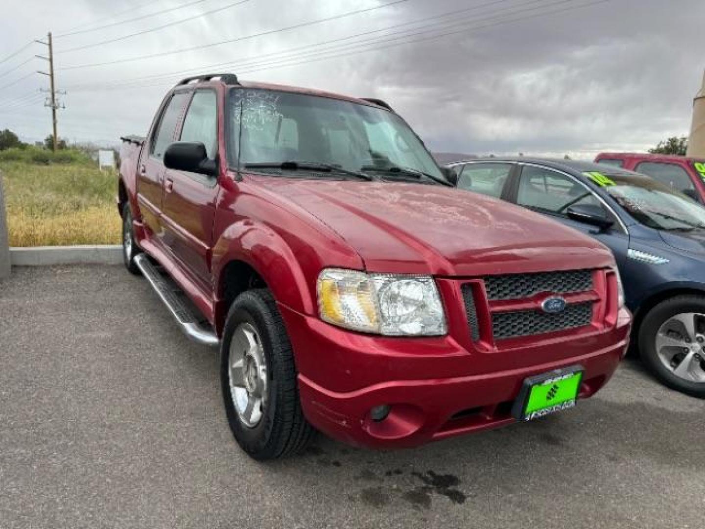 2004 Red Fire Metallic /Medium Dark Flint Cloth Interior Ford Explorer Sport Trac XLT 2WD (1FMZU67K24U) with an 4.0L V6 SOHC 12V FFV engine, 5-Speed Automatic transmission, located at 1865 East Red Hills Pkwy, St. George, 84770, (435) 628-0023, 37.120850, -113.543640 - Photo#0