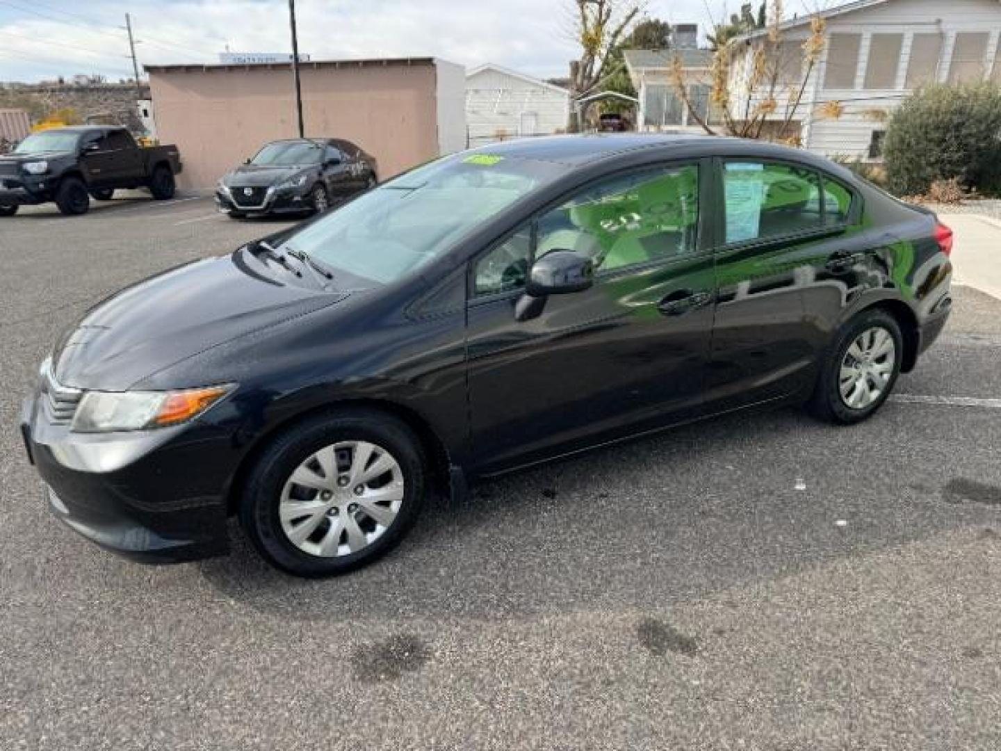 2012 Crystal Black Pearl /Beige Cloth Interior Honda Civic LX Sedan 5-Speed AT (2HGFB2F57CH) with an 1.8L L4 SOHC 16V engine, 5-Speed Automatic transmission, located at 940 North Main Street, Cedar City, UT, 84720, (435) 628-0023, 37.692936, -113.061897 - Photo#4