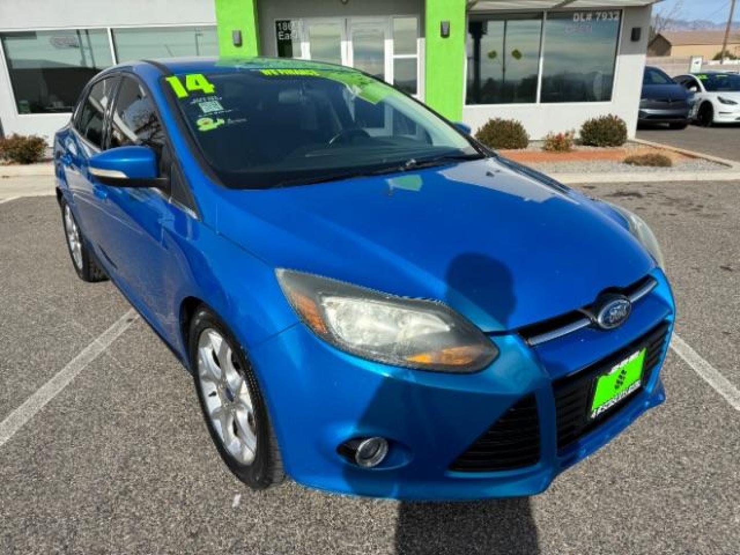 2014 Performance Blue Metallic /Charcoal Black Ford Focus Titanium Sedan (1FADP3J2XEL) with an 2.0L L4 DOHC 16V engine, 6-Speed Automatic transmission, located at 940 North Main Street, Cedar City, UT, 84720, (435) 628-0023, 37.692936, -113.061897 - Photo#1