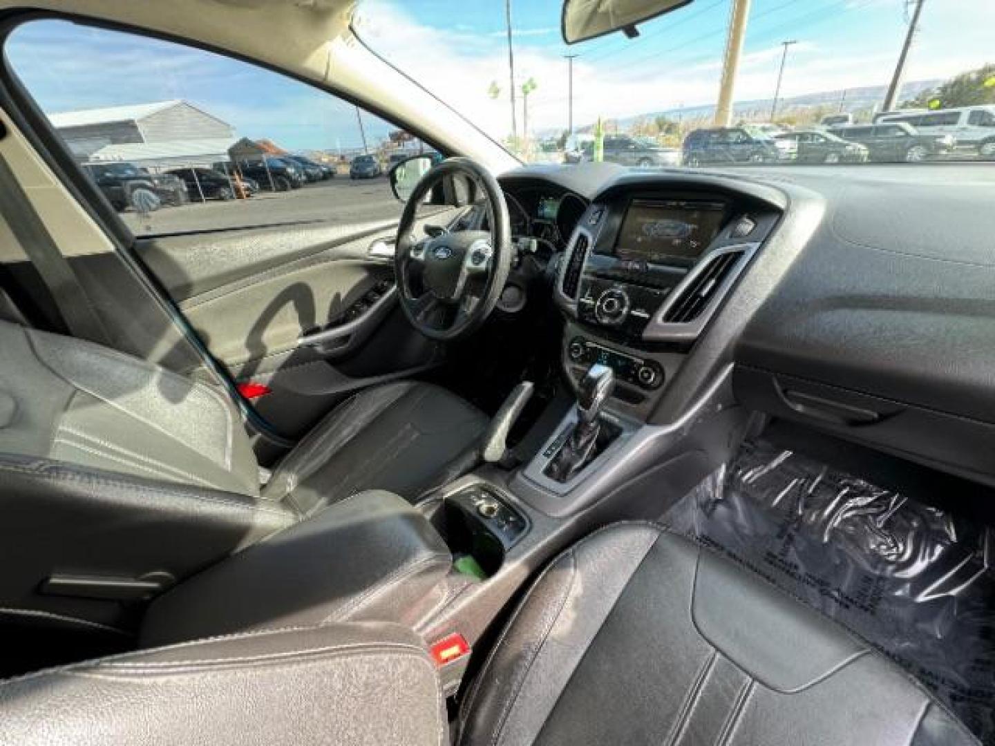 2014 Performance Blue Metallic /Charcoal Black Ford Focus Titanium Sedan (1FADP3J2XEL) with an 2.0L L4 DOHC 16V engine, 6-Speed Automatic transmission, located at 940 North Main Street, Cedar City, UT, 84720, (435) 628-0023, 37.692936, -113.061897 - Photo#35