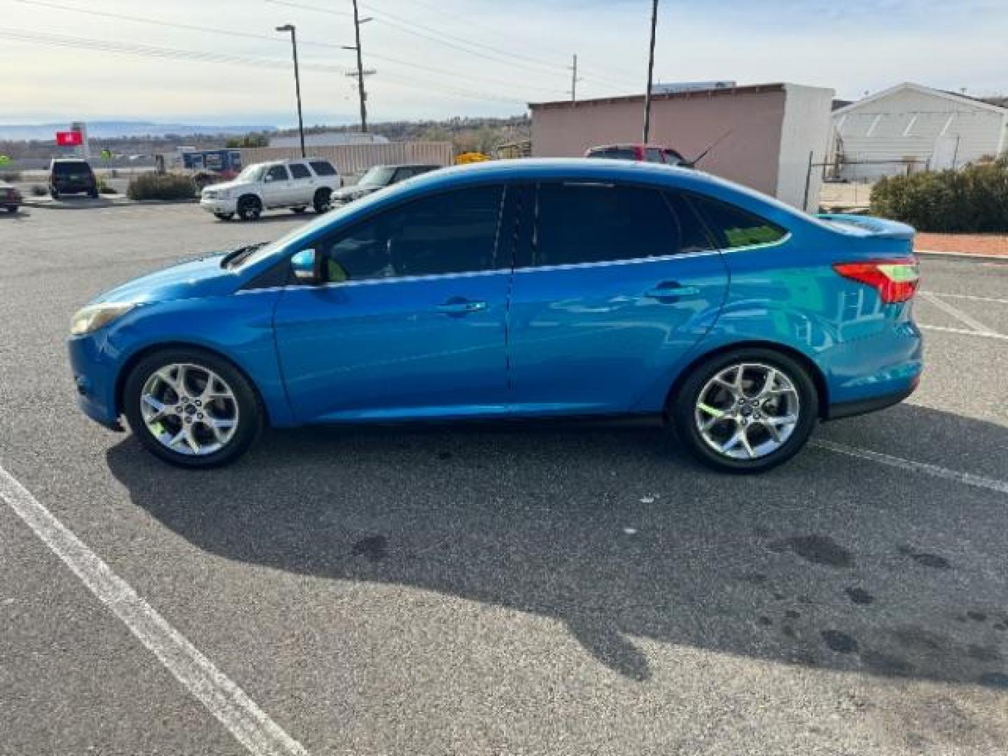 2014 Performance Blue Metallic /Charcoal Black Ford Focus Titanium Sedan (1FADP3J2XEL) with an 2.0L L4 DOHC 16V engine, 6-Speed Automatic transmission, located at 940 North Main Street, Cedar City, UT, 84720, (435) 628-0023, 37.692936, -113.061897 - Photo#5