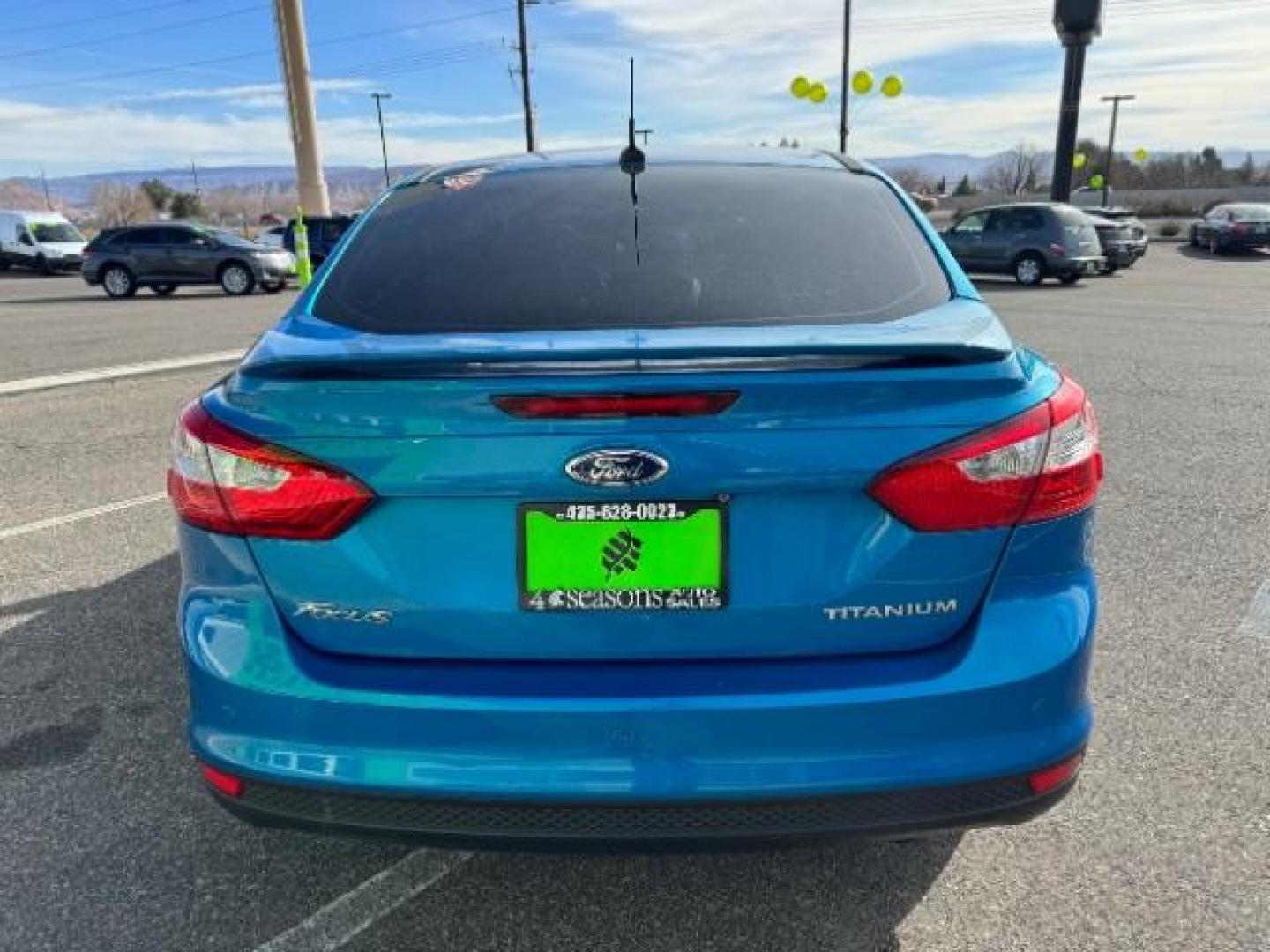 2014 Performance Blue Metallic /Charcoal Black Ford Focus Titanium Sedan (1FADP3J2XEL) with an 2.0L L4 DOHC 16V engine, 6-Speed Automatic transmission, located at 940 North Main Street, Cedar City, UT, 84720, (435) 628-0023, 37.692936, -113.061897 - Photo#7