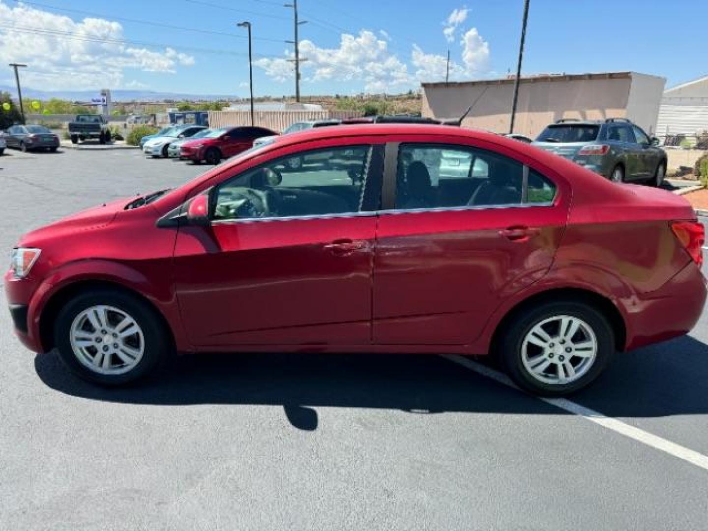 2014 Crystal Red Tintcoat /Jet Black/Dark Titanium Chevrolet Sonic LT Auto Sedan (1G1JC5SH5E4) with an 1.8L L4 DOHC 24V engine, 6-Speed Automatic transmission, located at 940 North Main Street, Cedar City, UT, 84720, (435) 628-0023, 37.692936, -113.061897 - We specialize in helping ALL people get the best financing available. No matter your credit score, good, bad or none we can get you an amazing rate. Had a bankruptcy, divorce, or repossessions? We give you the green light to get your credit back on the road. Low down and affordable payments that fit - Photo#3