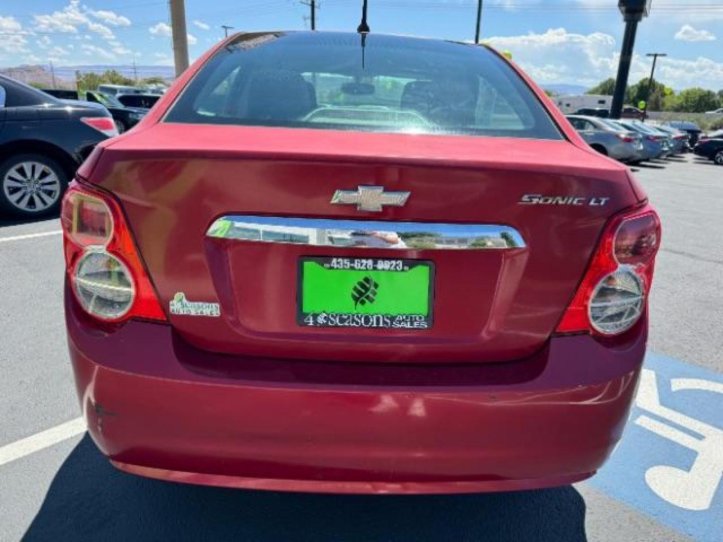 2014 Crystal Red Tintcoat /Jet Black/Dark Titanium Chevrolet Sonic LT Auto Sedan (1G1JC5SH5E4) with an 1.8L L4 DOHC 24V engine, 6-Speed Automatic transmission, located at 940 North Main Street, Cedar City, UT, 84720, (435) 628-0023, 37.692936, -113.061897 - We specialize in helping ALL people get the best financing available. No matter your credit score, good, bad or none we can get you an amazing rate. Had a bankruptcy, divorce, or repossessions? We give you the green light to get your credit back on the road. Low down and affordable payments that fit - Photo#5