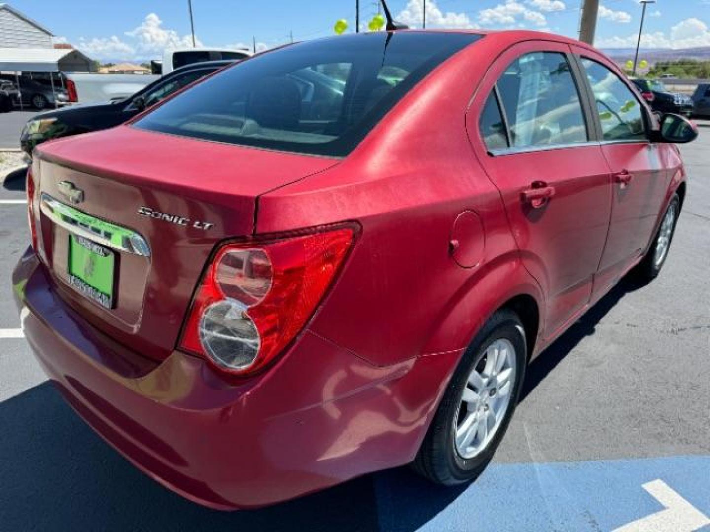 2014 Crystal Red Tintcoat /Jet Black/Dark Titanium Chevrolet Sonic LT Auto Sedan (1G1JC5SH5E4) with an 1.8L L4 DOHC 24V engine, 6-Speed Automatic transmission, located at 940 North Main Street, Cedar City, UT, 84720, (435) 628-0023, 37.692936, -113.061897 - We specialize in helping ALL people get the best financing available. No matter your credit score, good, bad or none we can get you an amazing rate. Had a bankruptcy, divorce, or repossessions? We give you the green light to get your credit back on the road. Low down and affordable payments that fit - Photo#6