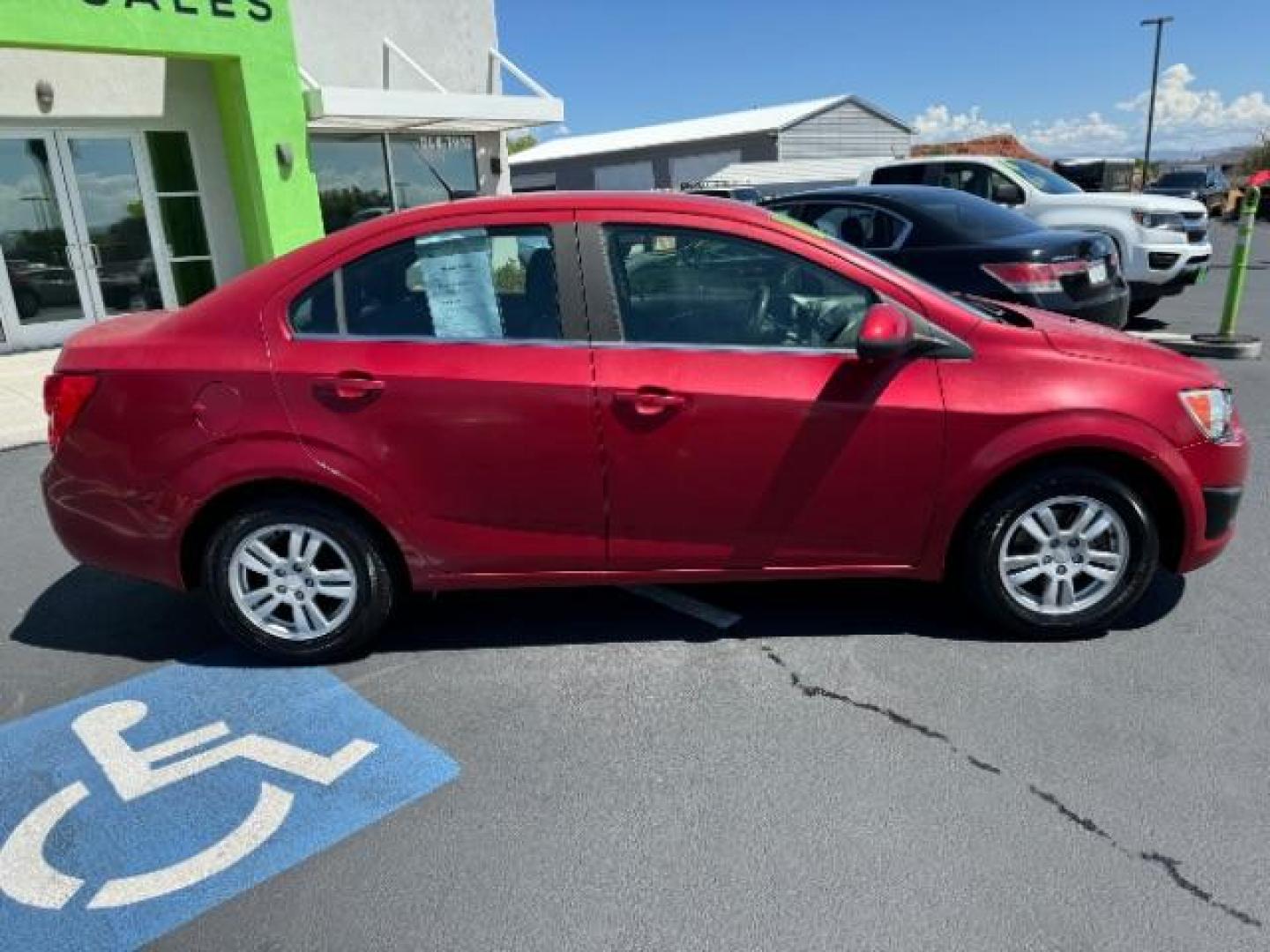 2014 Crystal Red Tintcoat /Jet Black/Dark Titanium Chevrolet Sonic LT Auto Sedan (1G1JC5SH5E4) with an 1.8L L4 DOHC 24V engine, 6-Speed Automatic transmission, located at 940 North Main Street, Cedar City, UT, 84720, (435) 628-0023, 37.692936, -113.061897 - We specialize in helping ALL people get the best financing available. No matter your credit score, good, bad or none we can get you an amazing rate. Had a bankruptcy, divorce, or repossessions? We give you the green light to get your credit back on the road. Low down and affordable payments that fit - Photo#7