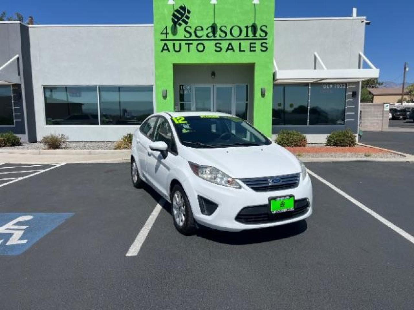 2012 Oxford White /Charcoal Black/Blue Cloth Interior Ford Fiesta SE Sedan (3FADP4BJ1CM) with an 1.6L L4 DOHC 16V engine, 6-Speed Automatic transmission, located at 940 North Main Street, Cedar City, UT, 84720, (435) 628-0023, 37.692936, -113.061897 - We specialize in helping ALL people get the best financing available. No matter your credit score, good, bad or none we can get you an amazing rate. Had a bankruptcy, divorce, or repossessions? We give you the green light to get your credit back on the road. Low down and affordable payments that fit - Photo#0