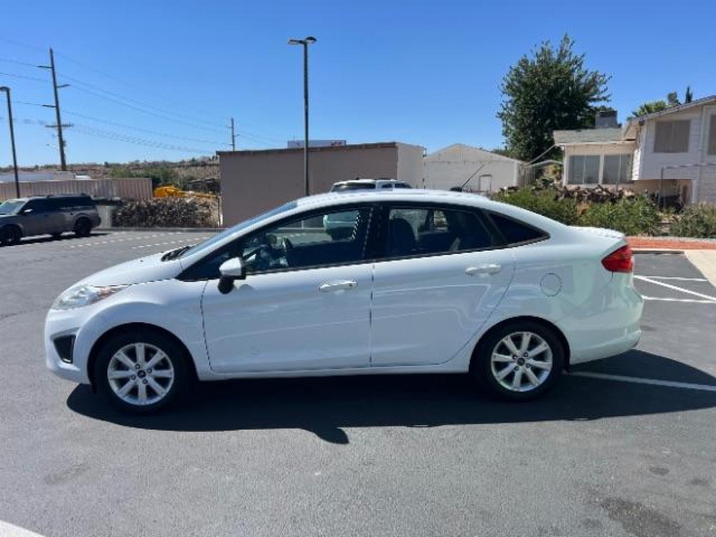 2012 Oxford White /Charcoal Black/Blue Cloth Interior Ford Fiesta SE Sedan (3FADP4BJ1CM) with an 1.6L L4 DOHC 16V engine, 6-Speed Automatic transmission, located at 940 North Main Street, Cedar City, UT, 84720, (435) 628-0023, 37.692936, -113.061897 - We specialize in helping ALL people get the best financing available. No matter your credit score, good, bad or none we can get you an amazing rate. Had a bankruptcy, divorce, or repossessions? We give you the green light to get your credit back on the road. Low down and affordable payments that fit - Photo#3