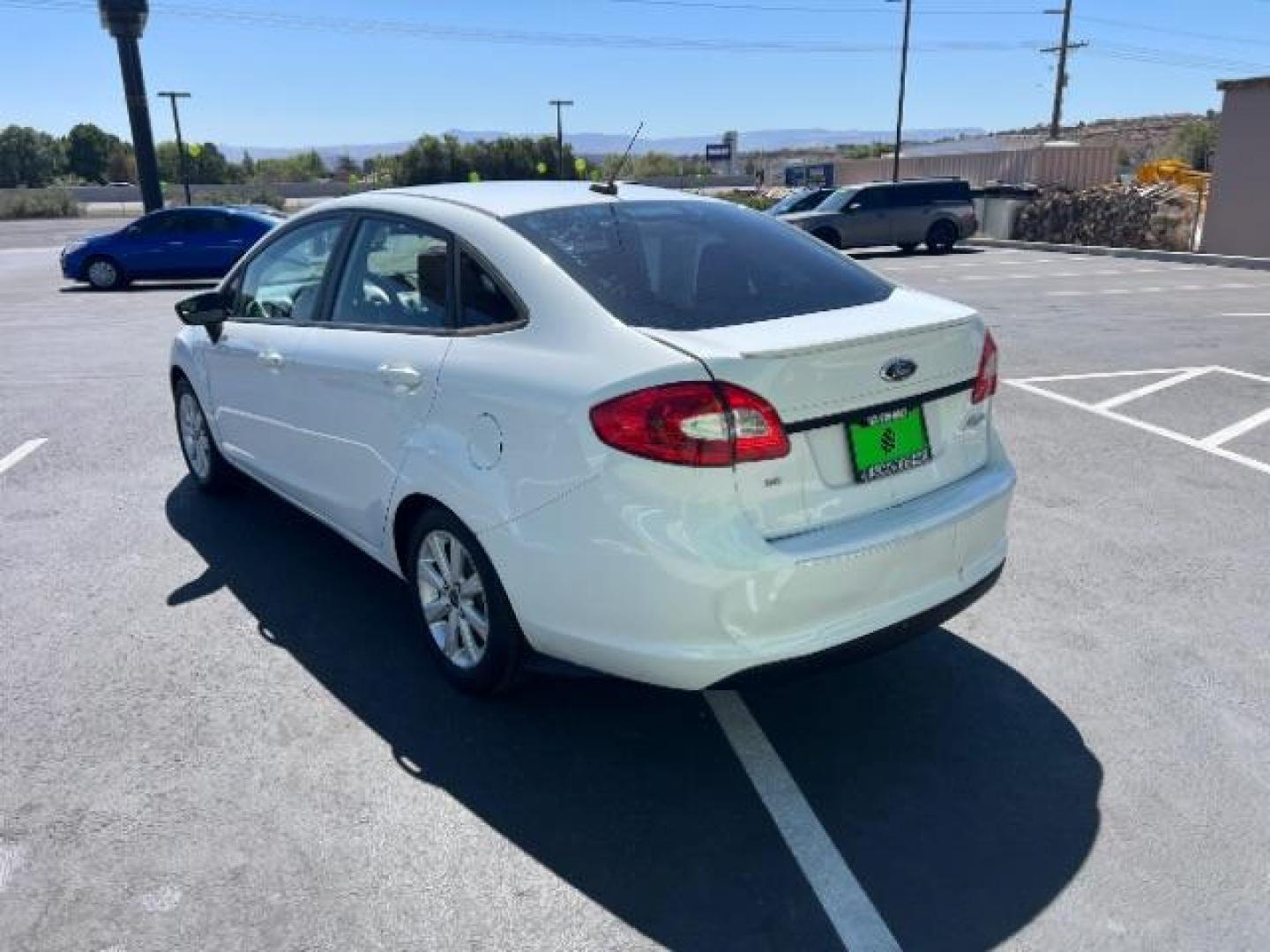 2012 Oxford White /Charcoal Black/Blue Cloth Interior Ford Fiesta SE Sedan (3FADP4BJ1CM) with an 1.6L L4 DOHC 16V engine, 6-Speed Automatic transmission, located at 940 North Main Street, Cedar City, UT, 84720, (435) 628-0023, 37.692936, -113.061897 - We specialize in helping ALL people get the best financing available. No matter your credit score, good, bad or none we can get you an amazing rate. Had a bankruptcy, divorce, or repossessions? We give you the green light to get your credit back on the road. Low down and affordable payments that fit - Photo#4