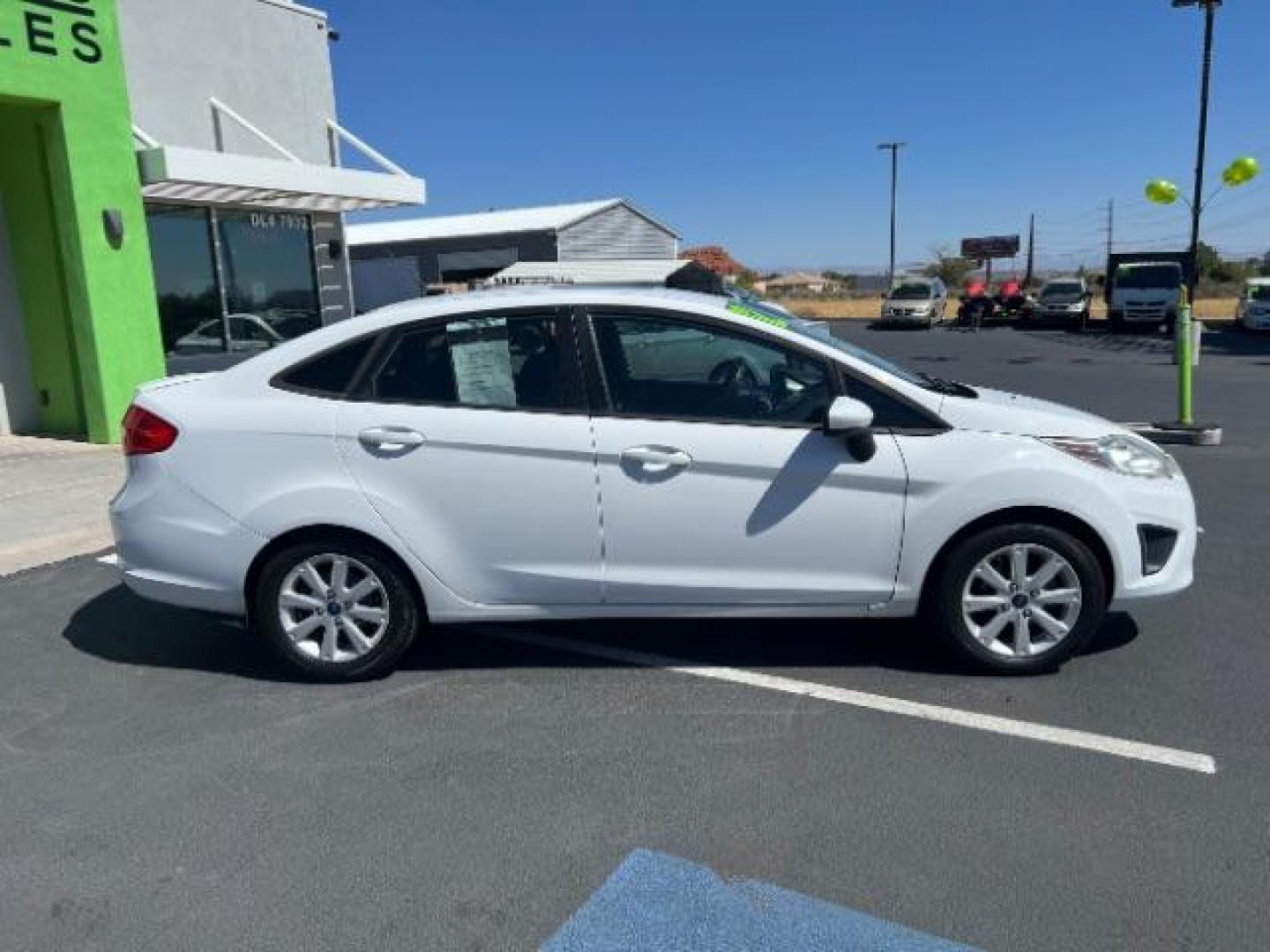 2012 Oxford White /Charcoal Black/Blue Cloth Interior Ford Fiesta SE Sedan (3FADP4BJ1CM) with an 1.6L L4 DOHC 16V engine, 6-Speed Automatic transmission, located at 940 North Main Street, Cedar City, UT, 84720, (435) 628-0023, 37.692936, -113.061897 - We specialize in helping ALL people get the best financing available. No matter your credit score, good, bad or none we can get you an amazing rate. Had a bankruptcy, divorce, or repossessions? We give you the green light to get your credit back on the road. Low down and affordable payments that fit - Photo#7